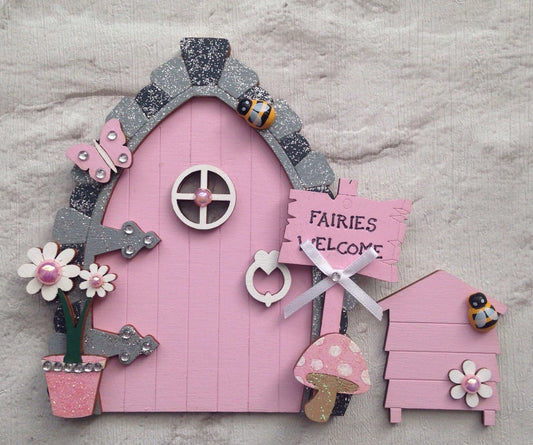 Pink fairy door with butterfly and beehive