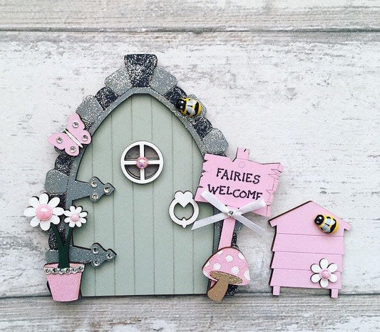 Beautiful Sage Green & Pink Wooden Fairy Door with Beehive  Invite some fairy magic into your home and capture your child's imagination with this beautiful handmade wooden fairy door set.