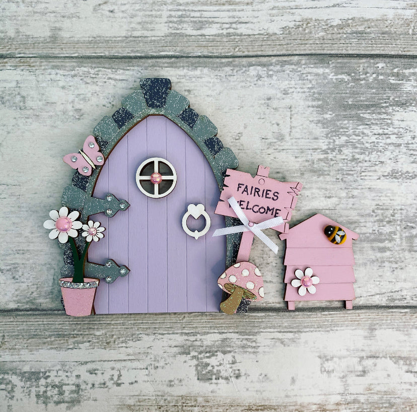 Beautiful Lilac & Pink Wooden Fairy Door With Beehive   Invite some fairy magic into your home and capture your child’s imagination with this beautiful handmade wooden fairy door.