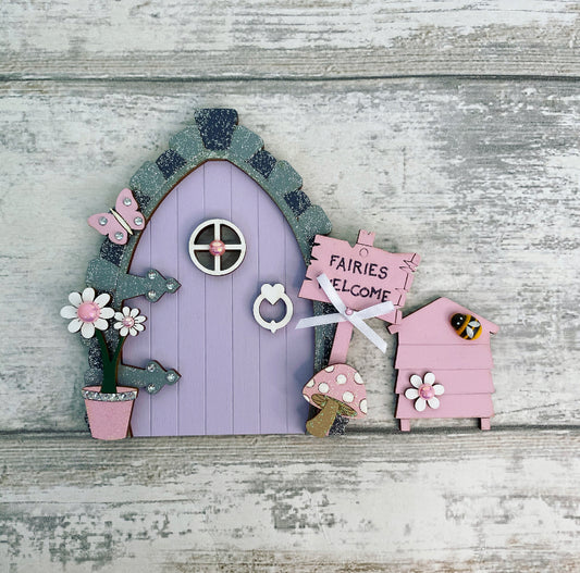 Beautiful Lilac & Pink Wooden Fairy Door With Beehive   Invite some fairy magic into your home and capture your child’s imagination with this beautiful handmade wooden fairy door.