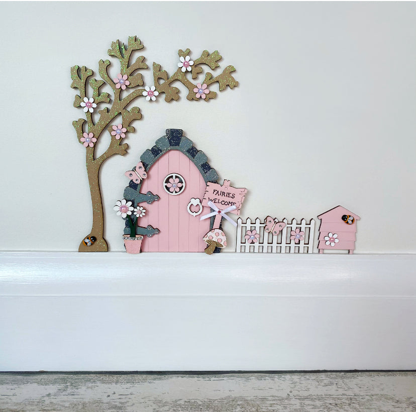 Beautiful Blush Pink Fairy Door Set with Blossom Tree, Fence & Beehive  Invite some fairy magic into your home and capture your child's imagination with this beautiful handmade wooden fairy door set.